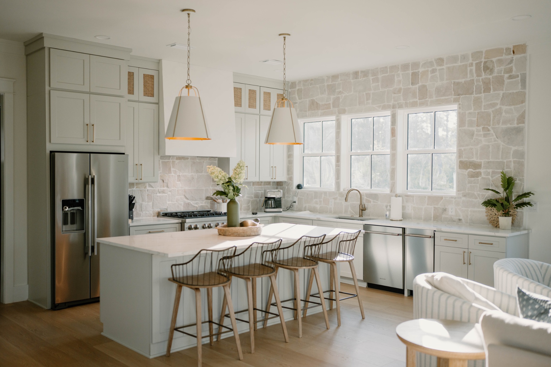 Open kitchen with stone backsplash and island