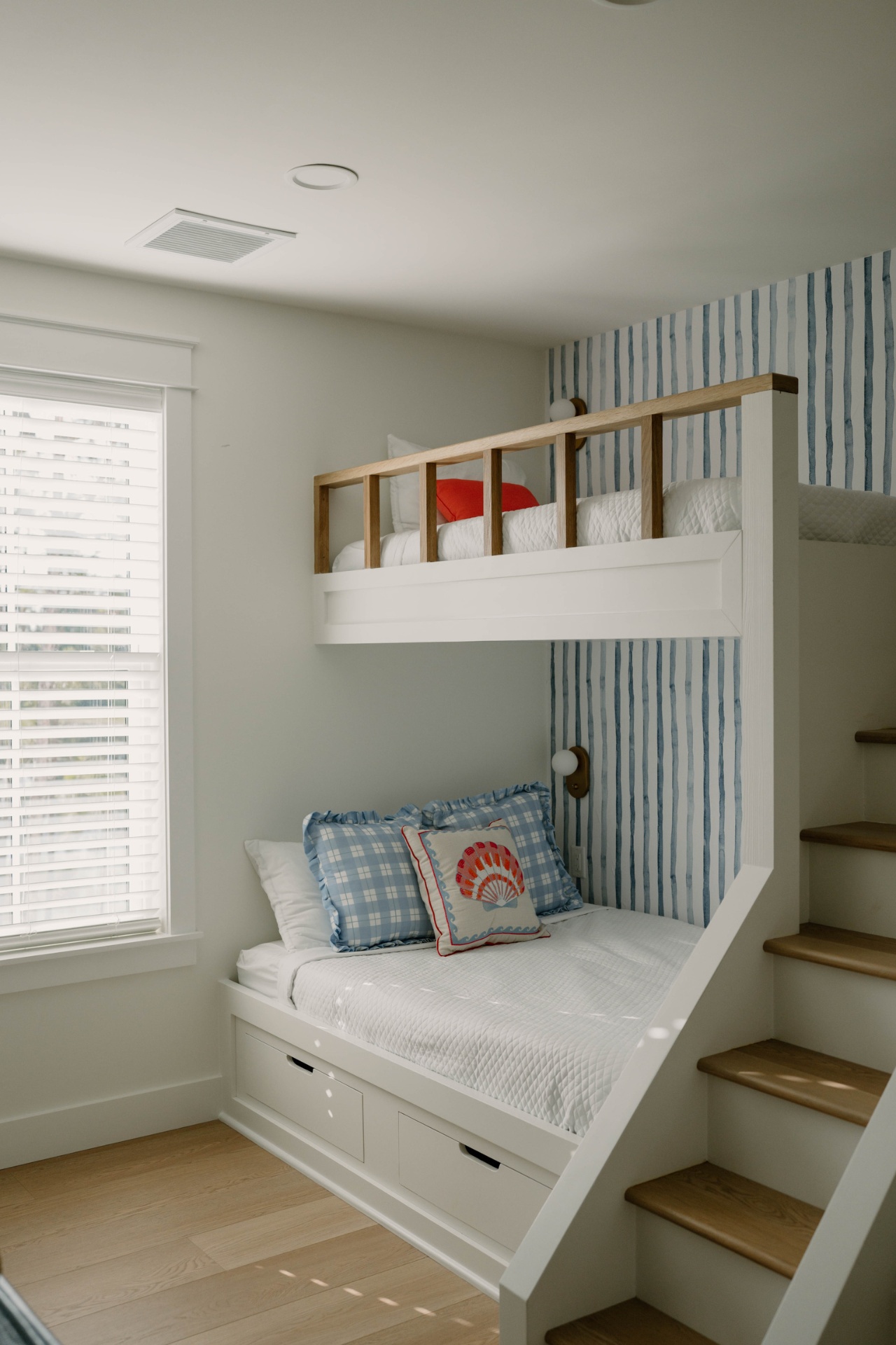 Bunk room with shell-stripe wallpaper