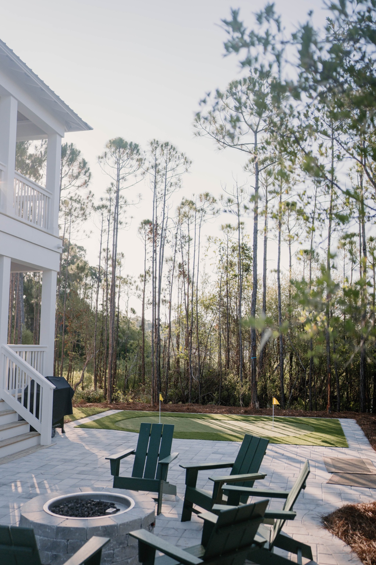 Backyard patio with firepit and putting green